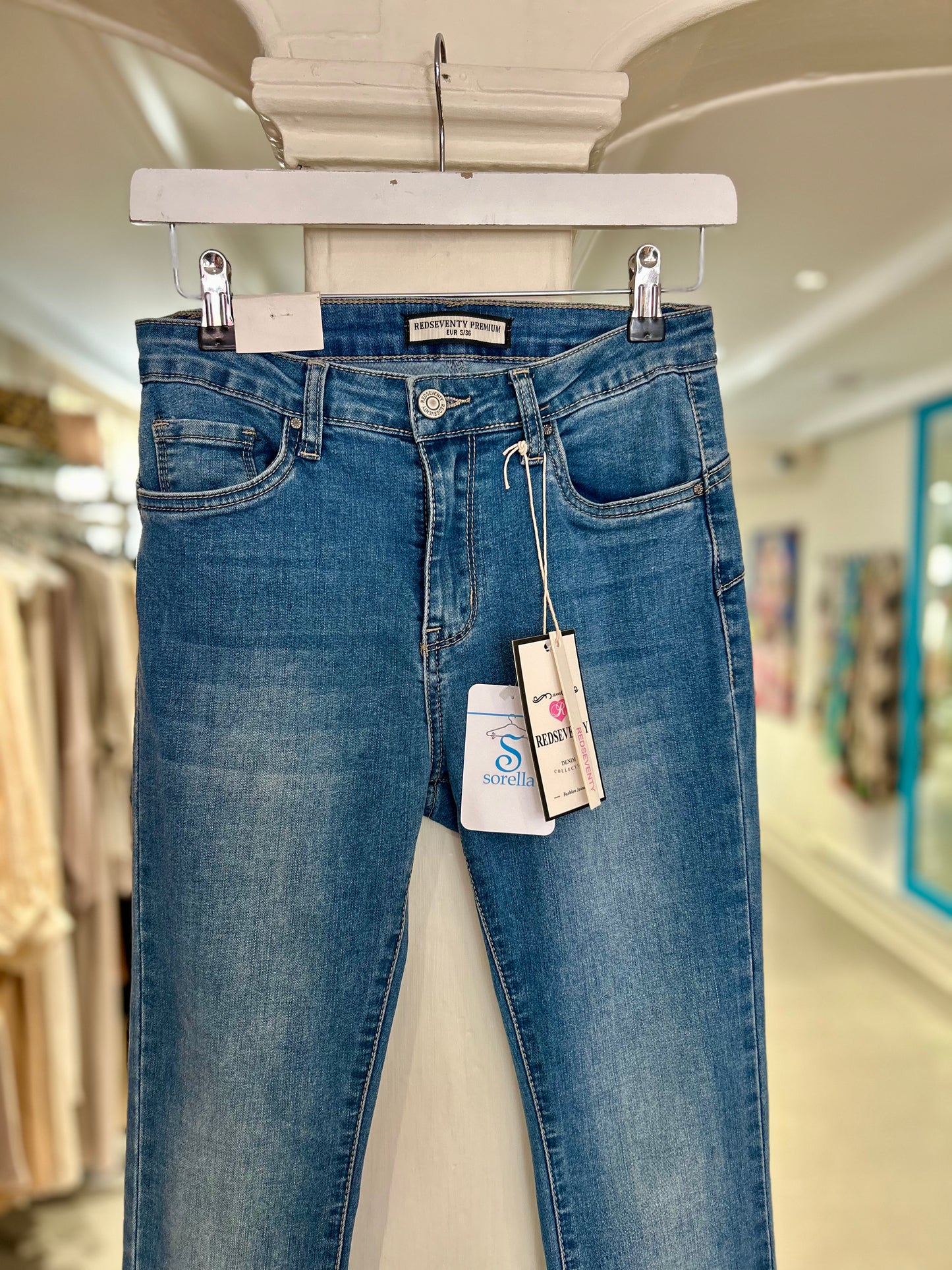 High Waisted Flared Jeans with Distressed Ankles - Mid Wash